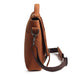 Brown leather bag with a shoulder strap on a white background